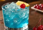 Blue Lotus Drink served in a short, wide glass filled with vibrant blue cocktail,