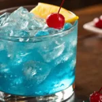 Blue Lotus Drink served in a short, wide glass filled with vibrant blue cocktail,