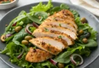 Pan-seared chicken paillard with lemon-butter sauce on arugula salad