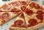 High protein pizza crust baked to a golden crisp, topped with melted cheese and pepperoni.