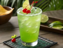 Vibrant green Liquid Maria Juana mocktail in a highball glass garnished with lime and mint, non-alcoholic tropical drink recipe