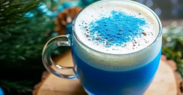 A glass of indigo-colored drink made from The Persian Blue Salt Trick Recipe, glowing under soft kitchen light.