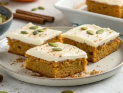 Sliced Pumpkin Bars with Cream Cheese Frosting ready to serve.