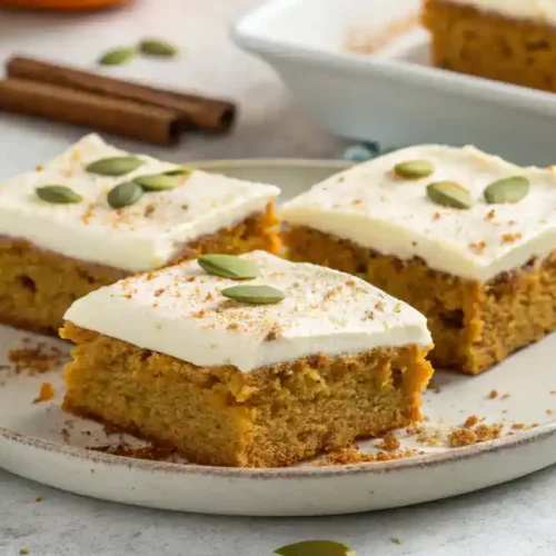 Sliced Pumpkin Bars with Cream Cheese Frosting ready to serve.
